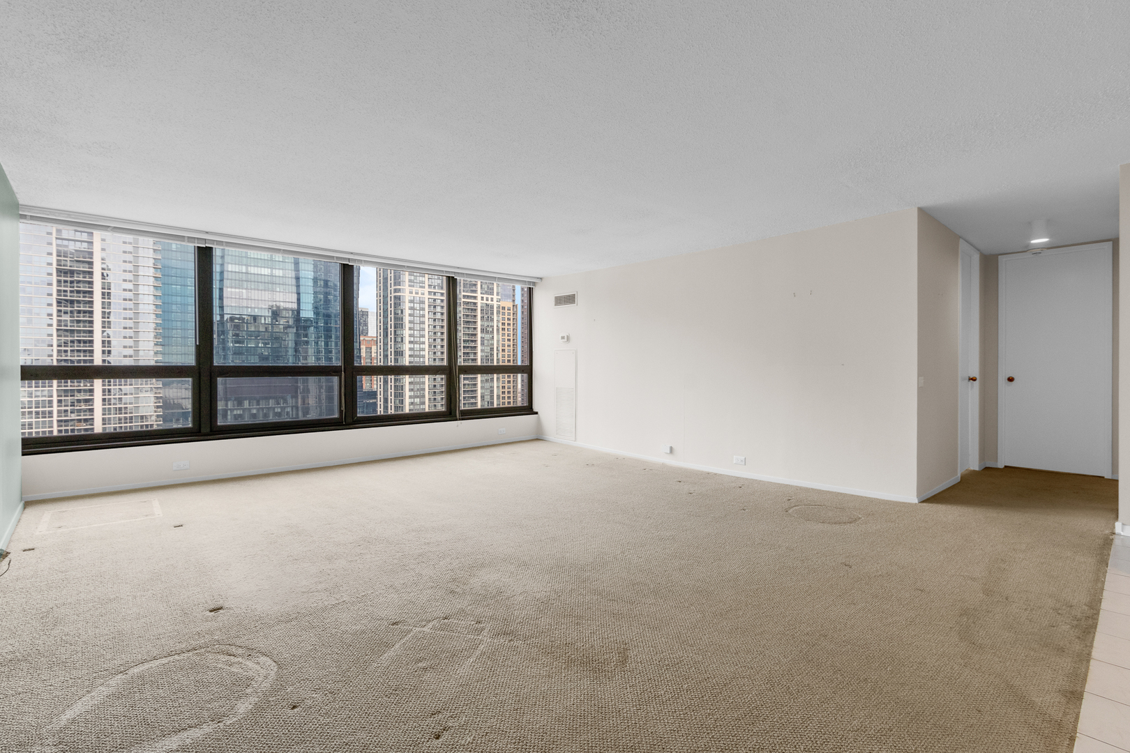 360 East Randolph Street, Unit 2307 Chicago, IL 60601 - Photo 3 of 34 a view of an empty room with a balcony