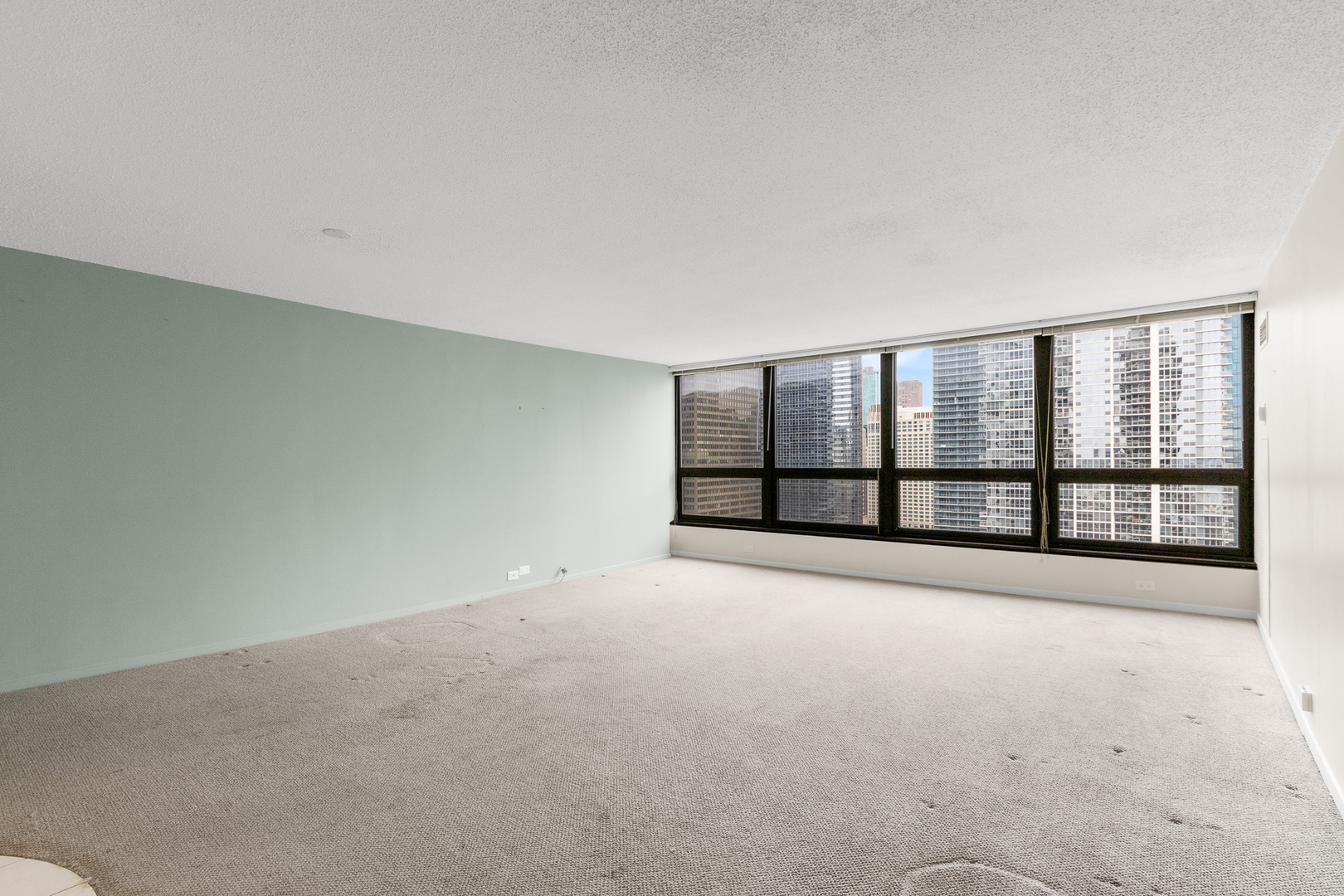 360 East Randolph Street, Unit 2307 Chicago, IL 60601 - Photo 4 of 34 wooden floor in an empty room with a window