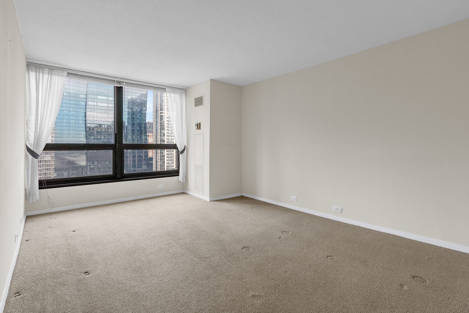360 East Randolph Street, Unit 2307 Chicago, IL 60601 - Photo 5 of 34 a view of an empty room with a window