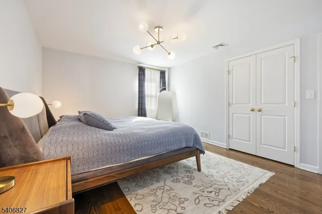 a bedroom with a bed lamps and a chandelier