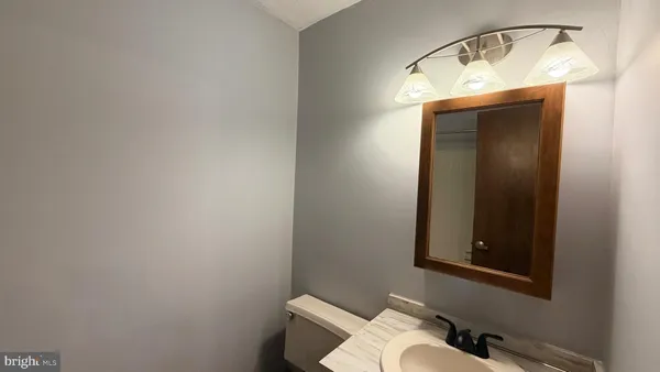 a bathroom with a toilet and a mirror