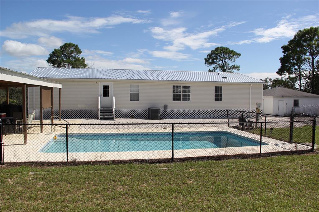 13127 Star Road Brooksville, FL 34613 - Photo 11 of 54 a view of a house with swimming pool