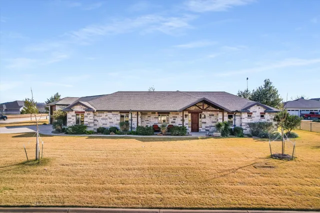 a front view of house with yard and swimming pool