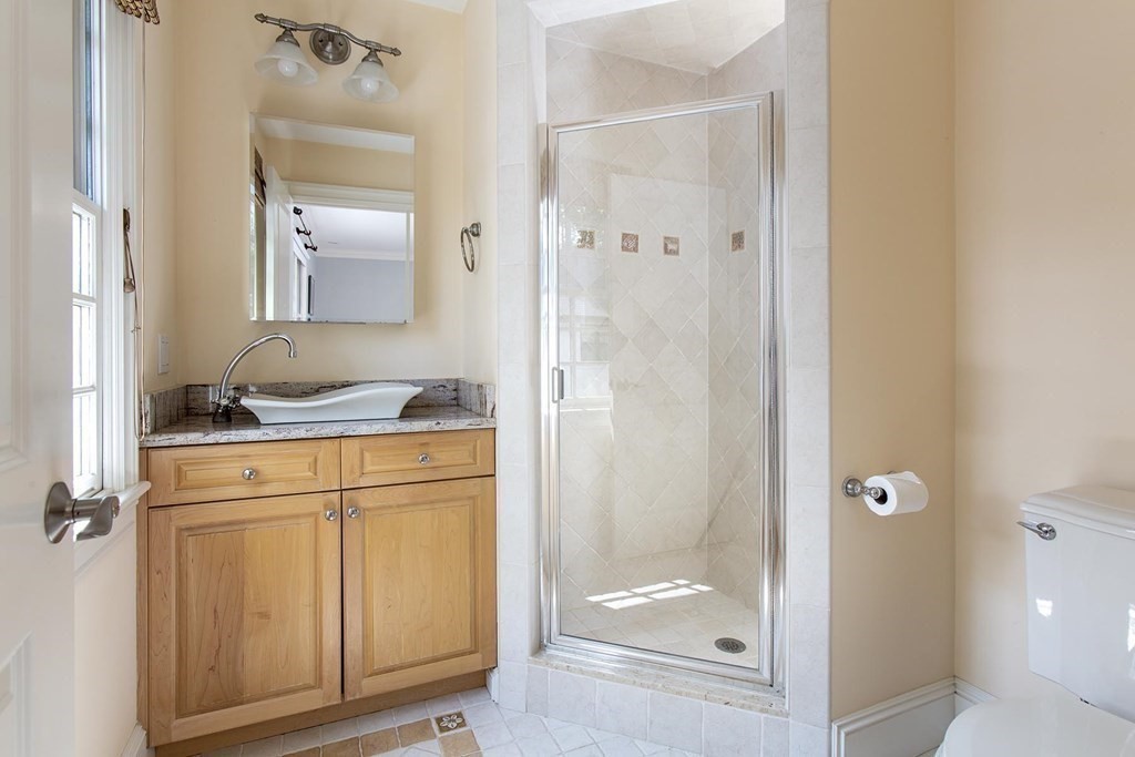 43 Carlton Road Newton, MA 02468 - Photo 14 of 23 a bathroom with a granite countertop sink and a mirror