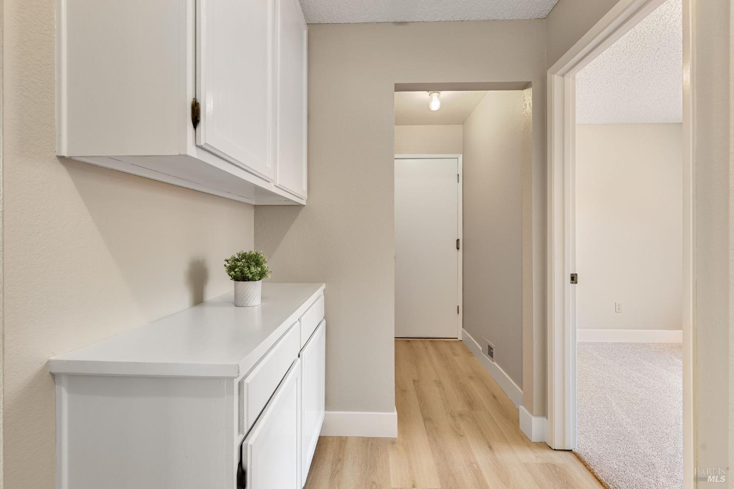 828 Stoneridge Circle Fairfield, CA 94534 - Photo 23 of 37 a hallway with cabinets and wooden floor