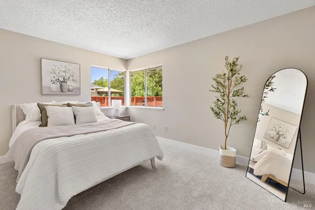 a spacious bedroom with a bed and a window