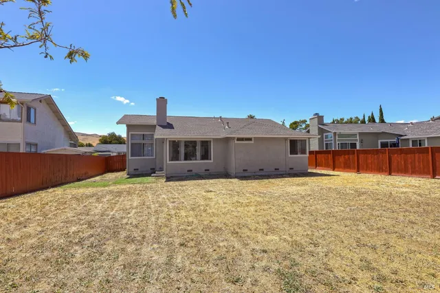 a backyard of a house with wooden fence