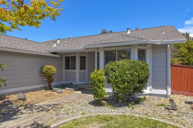 a front view of a house with garden