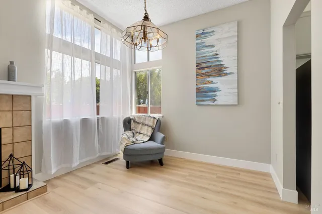 a living room with furniture and a chandelier