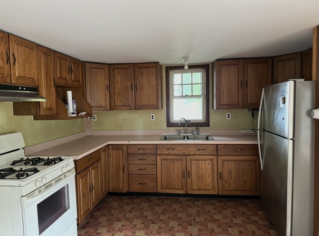 86 Main Street Douglas, MA 01516 - Photo 2 of 6 a kitchen that has a sink and a stove