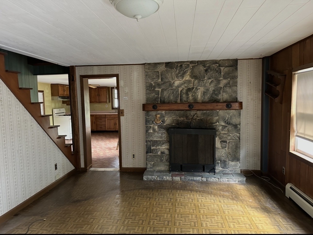 86 Main Street Douglas, MA 01516 - Photo 3 of 6 a view of a livingroom with wooden floor and a fireplace