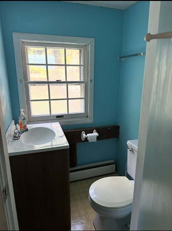 86 Main Street Douglas, MA 01516 - Photo 4 of 6 a bathroom with a sink a toilet and a window