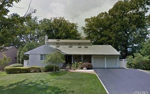 22 Donald Drive Syosset, NY 11791 - Photo 1 of 1 View of front of house with driveway, a front yard, and a garage