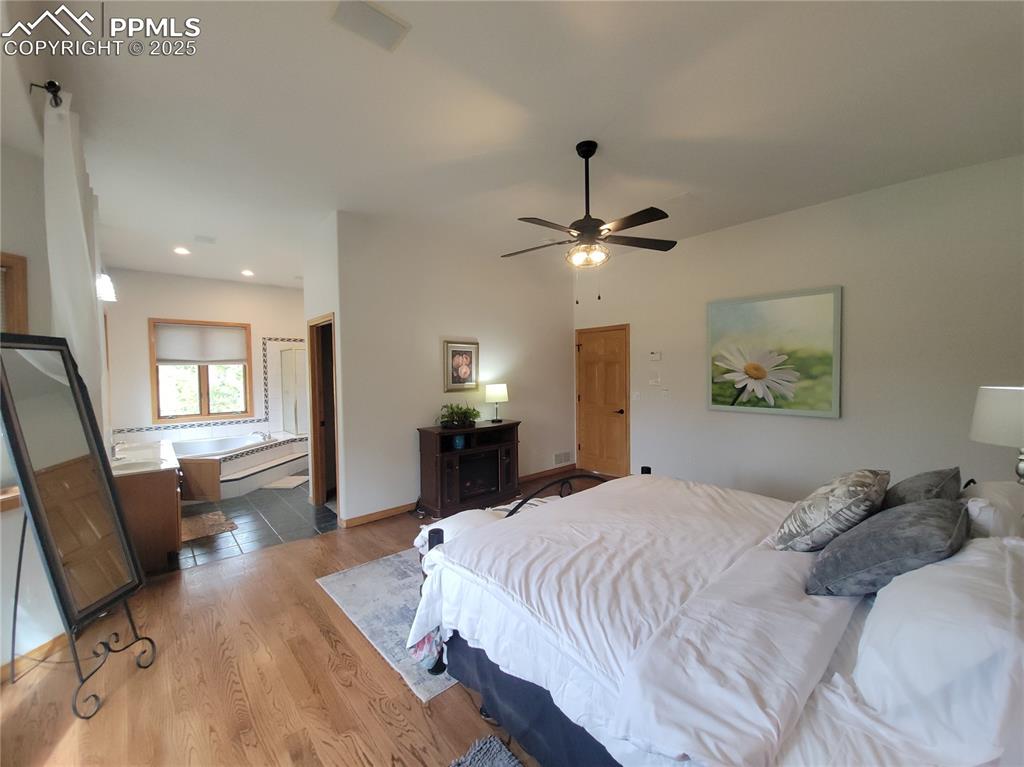 730 Winding Hills Road Monument, CO 80132 - Photo 15 of 42 a bedroom with a bed and furniture