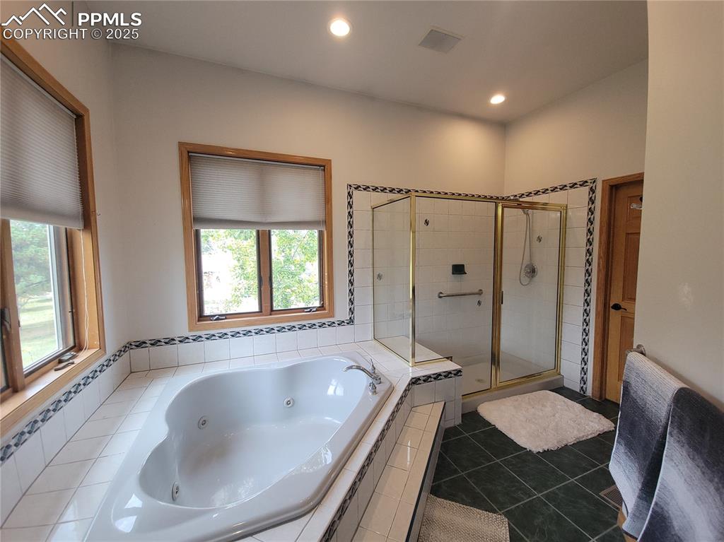 730 Winding Hills Road Monument, CO 80132 - Photo 16 of 42 a bathroom with a granite countertop tub shower and sink
