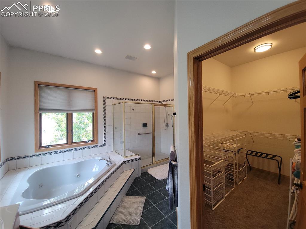 730 Winding Hills Road Monument, CO 80132 - Photo 17 of 42 a bathroom with a granite countertop tub mirror and window