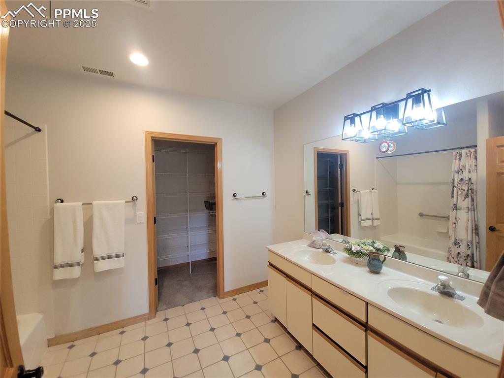 730 Winding Hills Road Monument, CO 80132 - Photo 29 of 42 a bathroom with a sink a toilet and a large mirror