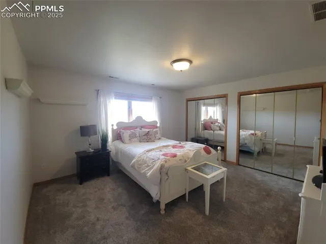 a bedroom with a bed and a mirror