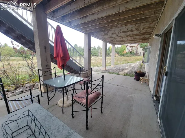 a view of deck with furniture and a backyard