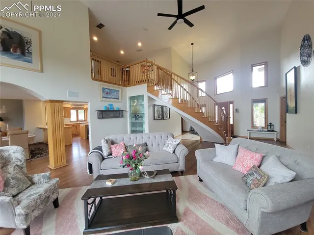 a living room with furniture and a chandelier