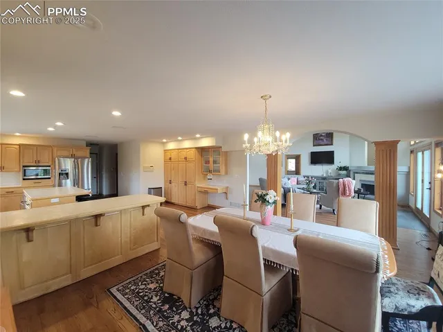 a large kitchen with a table and chairs
