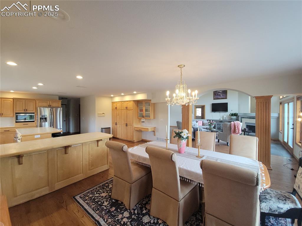 730 Winding Hills Road Monument, CO 80132 - Photo 10 of 42 a large kitchen with a table and chairs