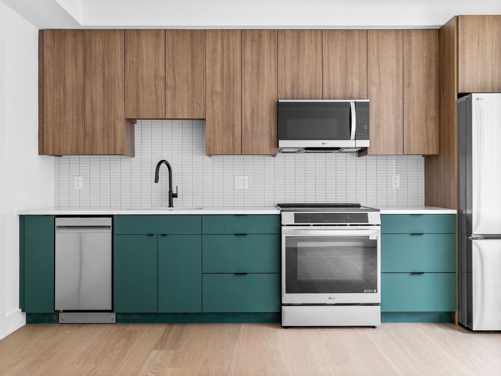 27 Dixwell Street, Unit 1 Boston, MA 02119 - Photo 2 of 13 a kitchen with a sink and a microwave