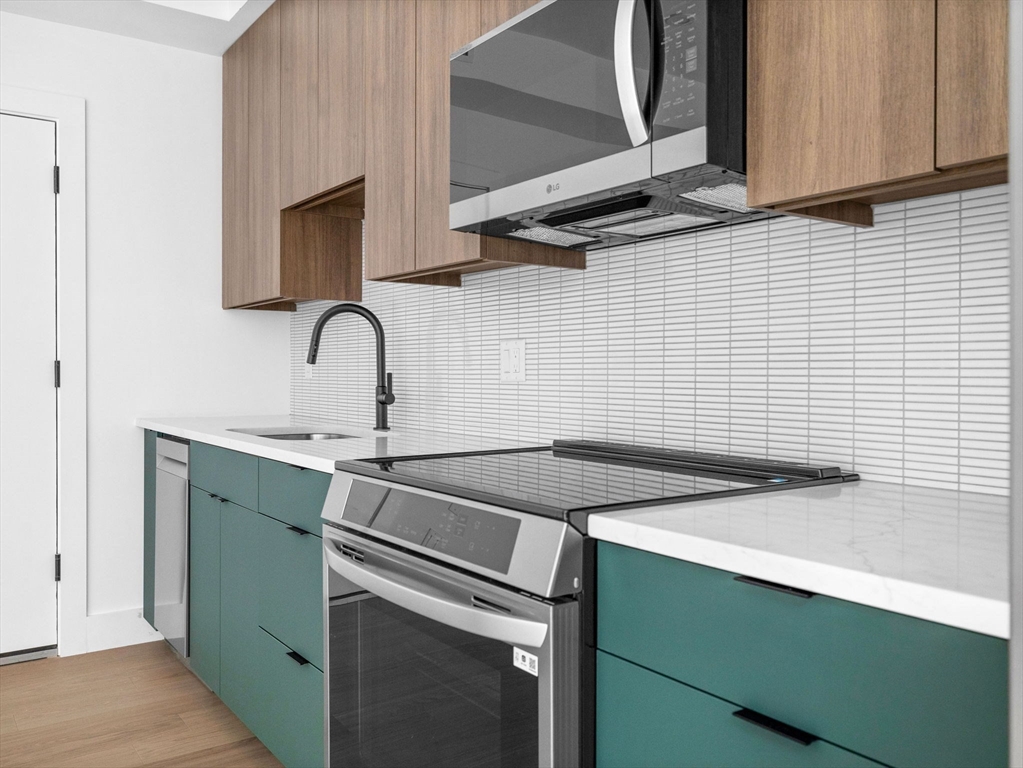 27 Dixwell Street, Unit 1 Boston, MA 02119 - Photo 3 of 13 a kitchen with a sink stove and microwave