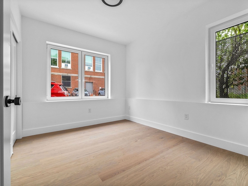 27 Dixwell Street, Unit 1 Boston, MA 02119 - Photo 8 of 13 an empty room with a window