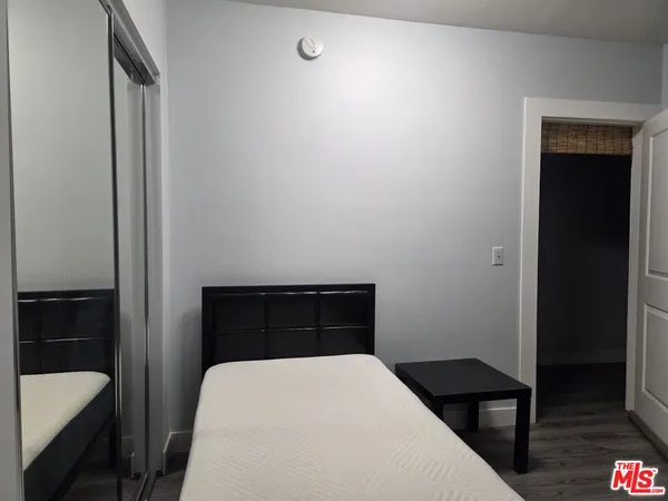 a bedroom with a bed and a table