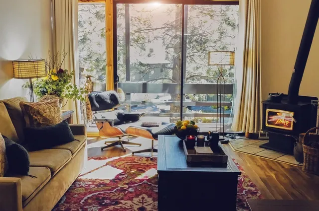 a living room with furniture and a floor to ceiling window