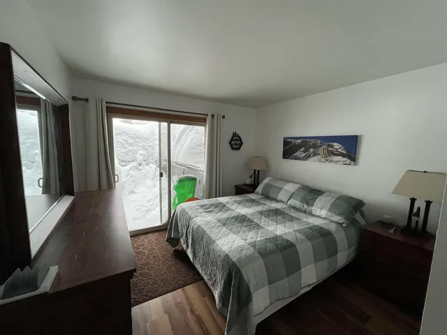 a bed sitting in a bedroom next to a window