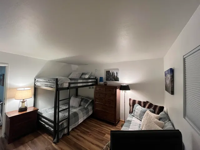 a bedroom with a bed and a night stand