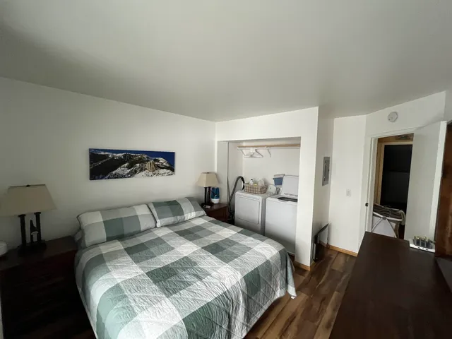 a bedroom with a bed and a large mirror