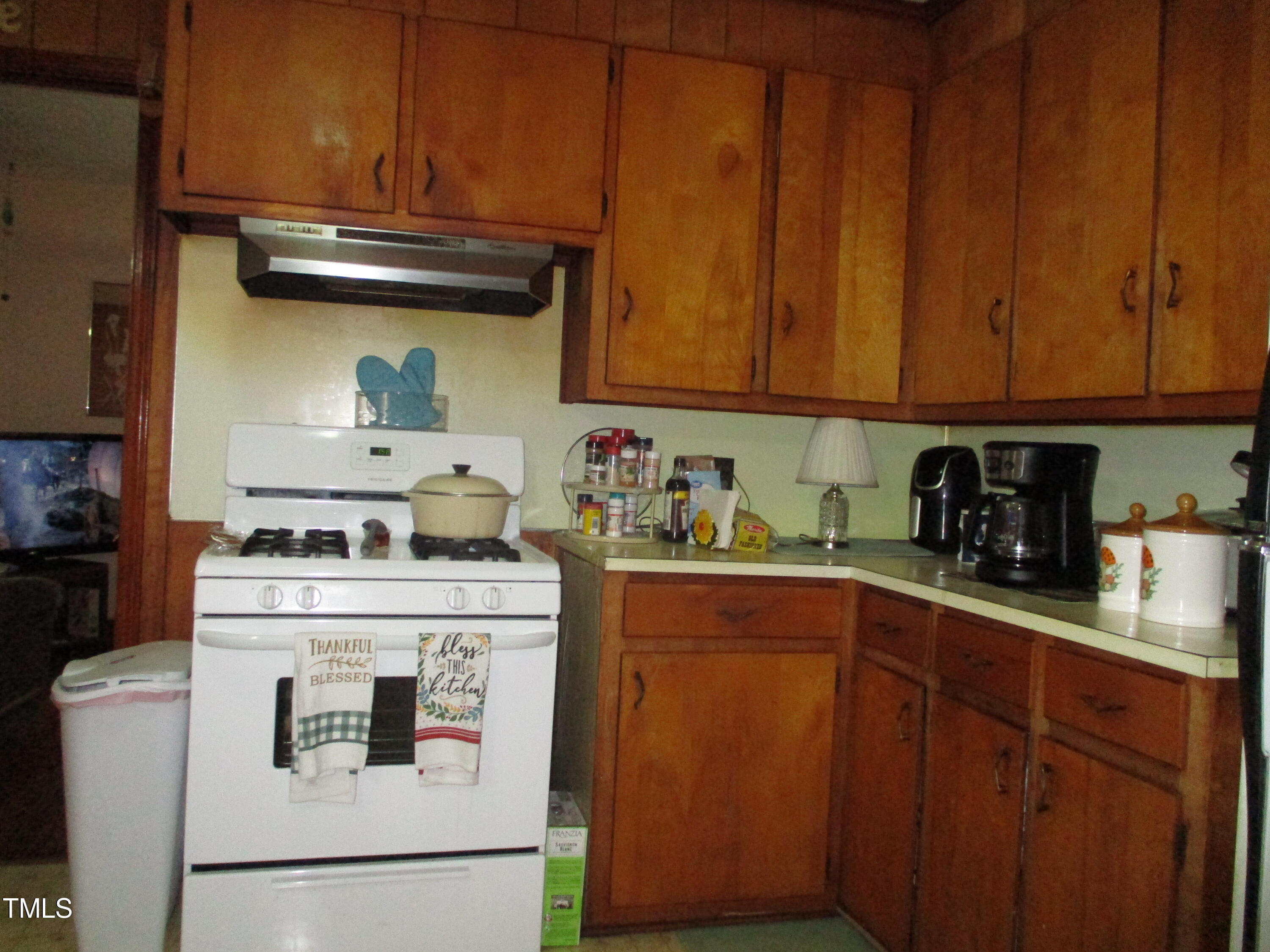 821 South Main Street Roxboro, NC 27573 - Photo 8 of 9 a kitchen with a stove top oven sink and cabinets