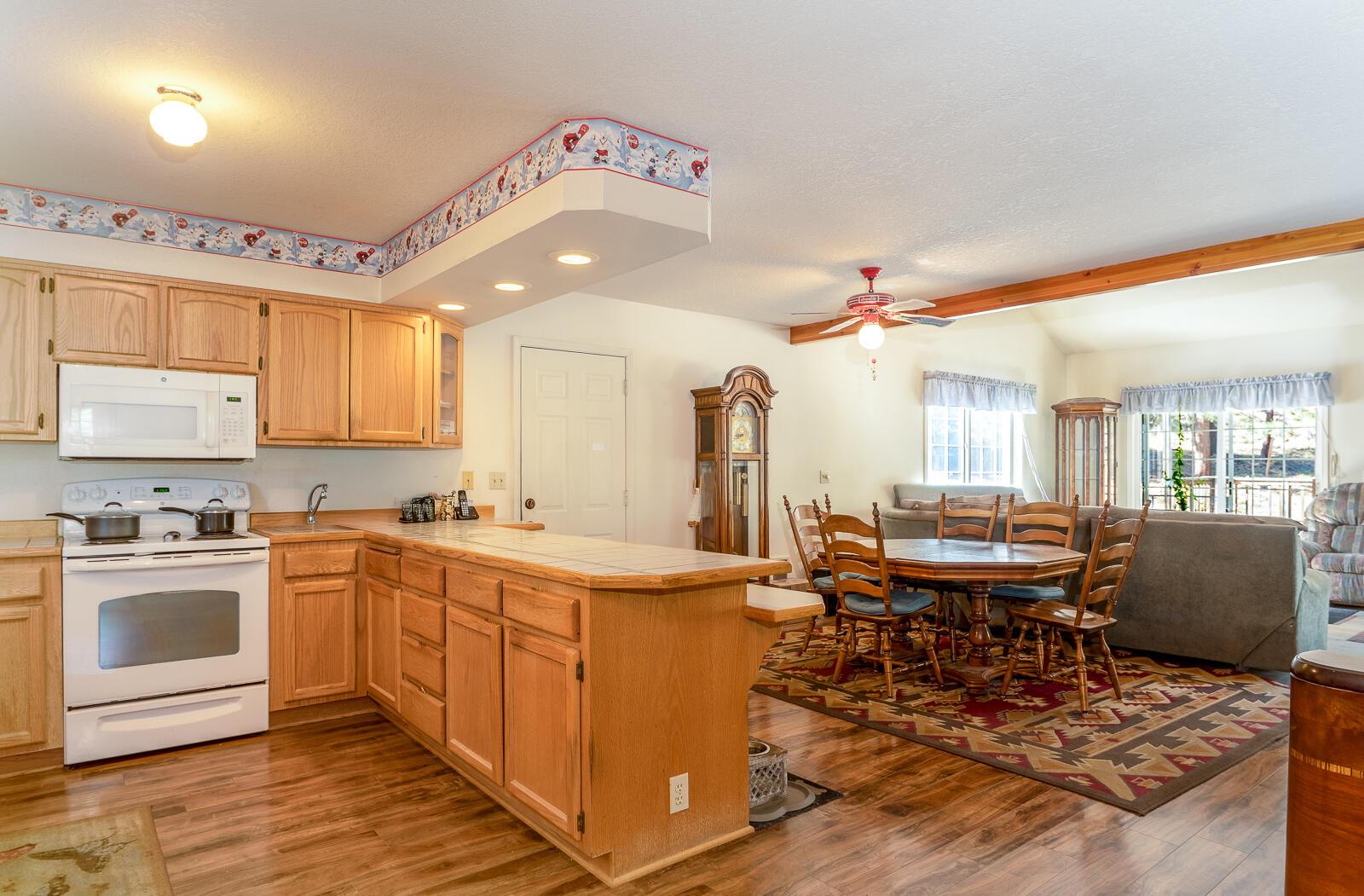 19793 Buck Canyon Road Bend, OR 97702 - Photo 5 of 33 a kitchen with stainless steel appliances kitchen island granite countertop a sink and cabinets