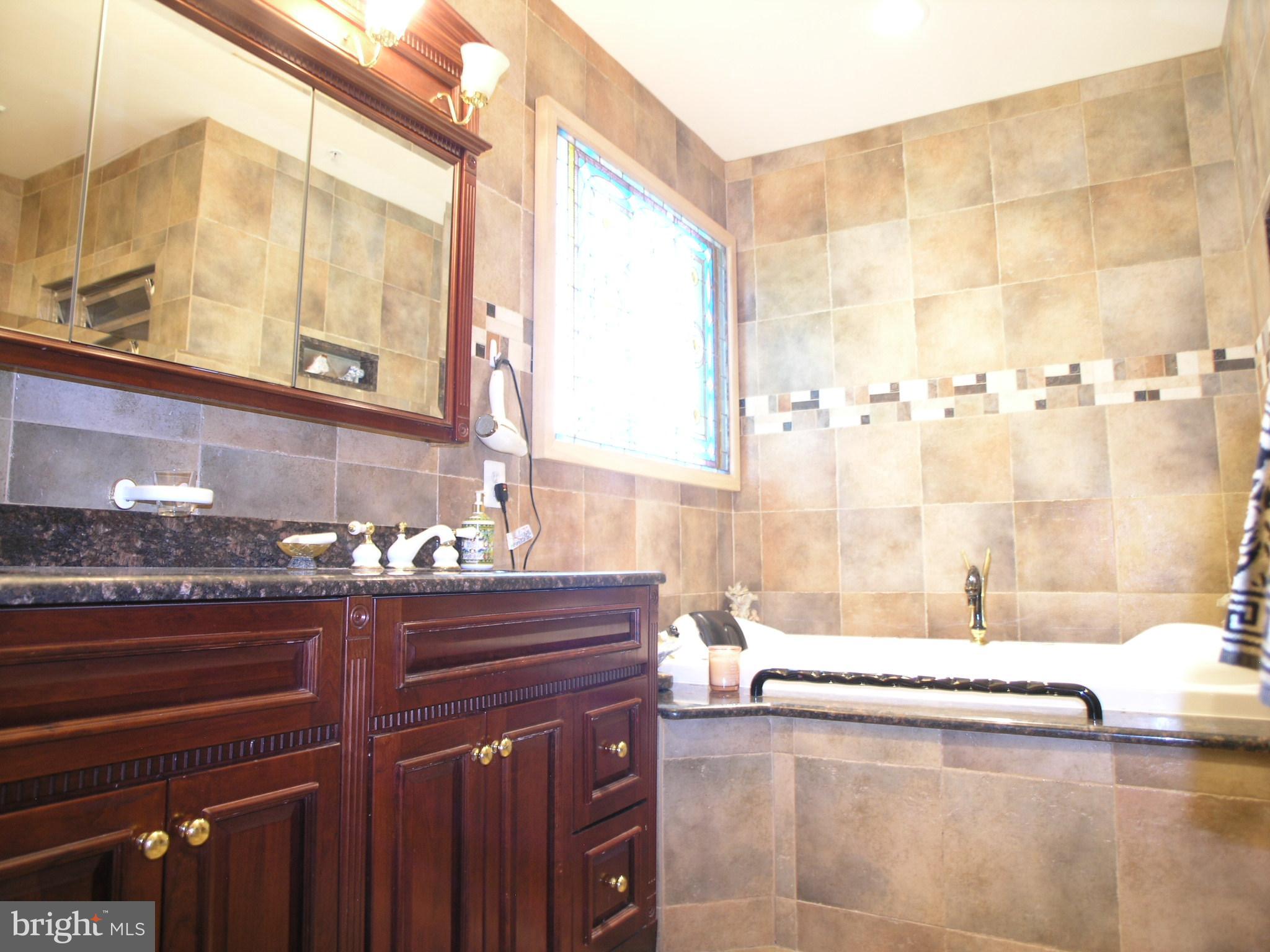 950 Nathaniel Trail Warminster, PA 18974 - Photo 14 of 26 a bathroom with a bathtub and a sink