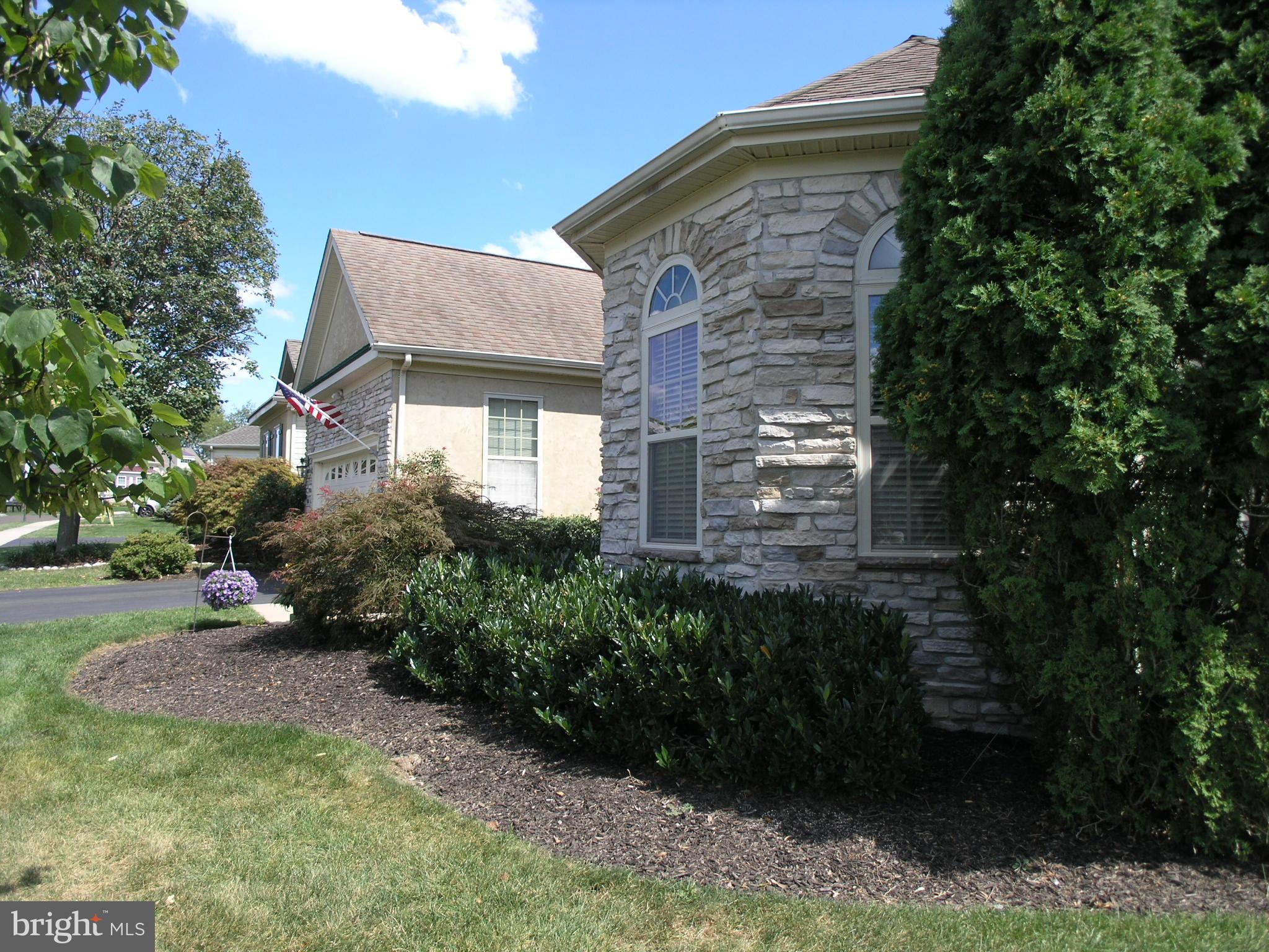 950 Nathaniel Trail Warminster, PA 18974 - Photo 2 of 26 a backyard of a house with plants and large trees