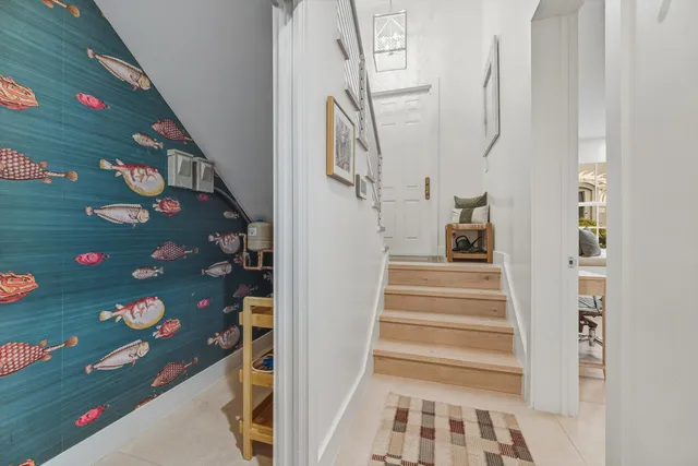 a view of staircase with lots of frames on wall