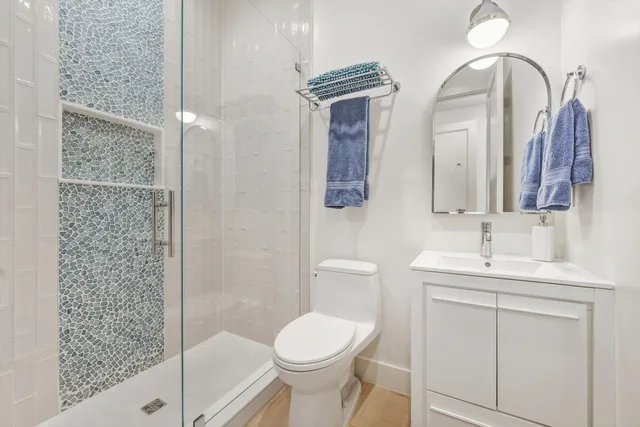 a bathroom with a toilet sink and mirror