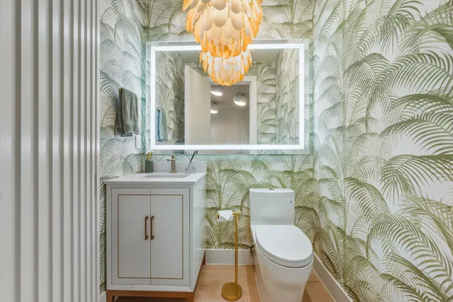 a bathroom with a sink a toilet and a mirror