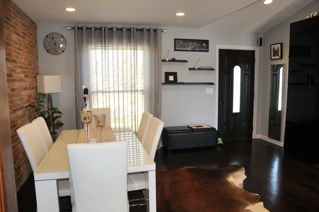 a dining room with furniture and wooden floor