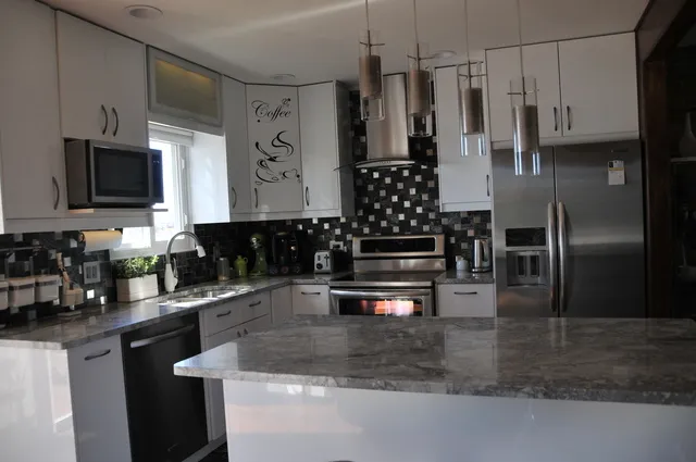 a kitchen with kitchen island a counter space a sink and appliances