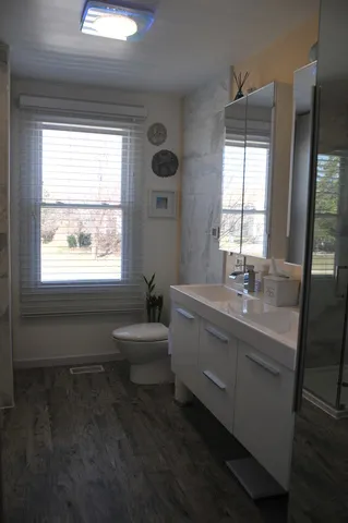 a bathroom with a double vanity sink window and mirror