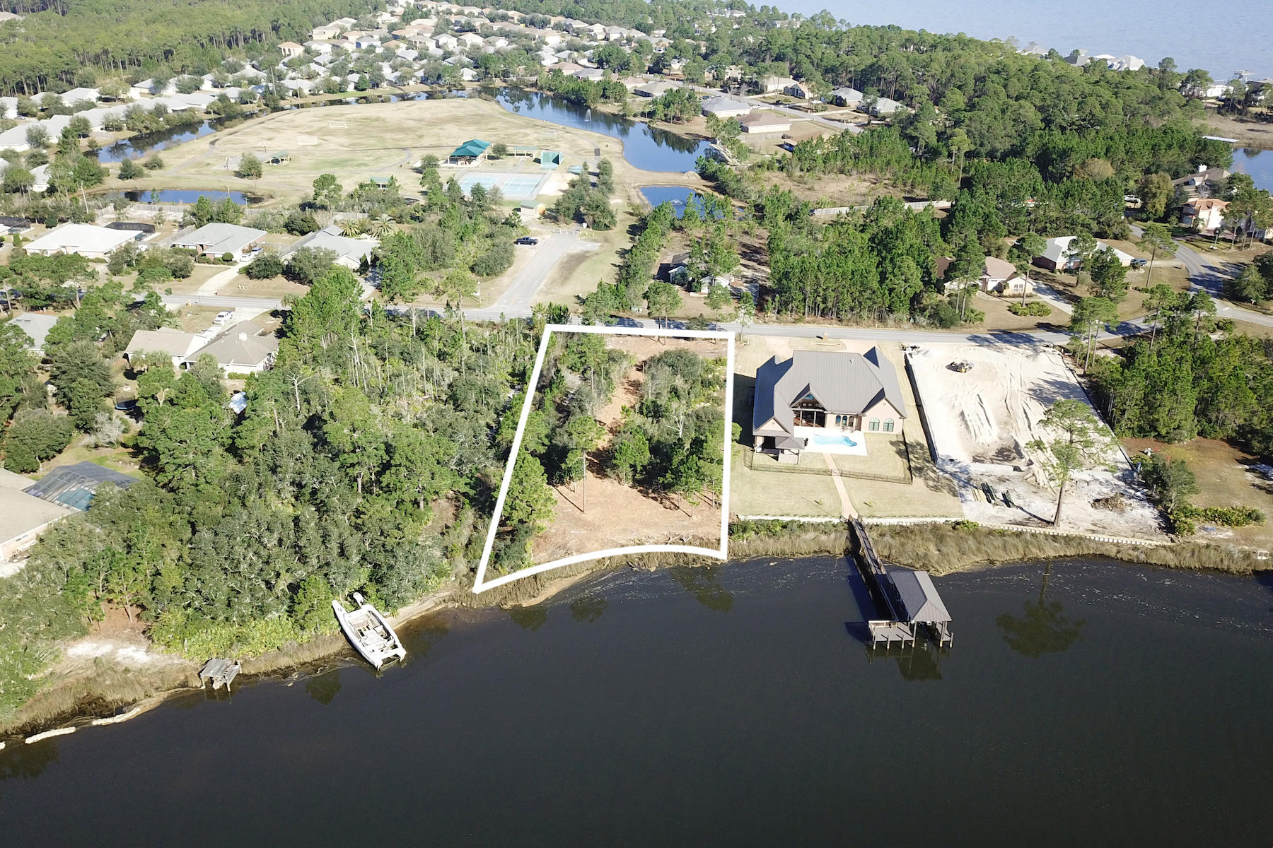 Lot 25 East Shipwreck Road Santa Rosa Beach, FL 32459 - Photo 3 of 10 an aerial view of a house with a yard and lake view