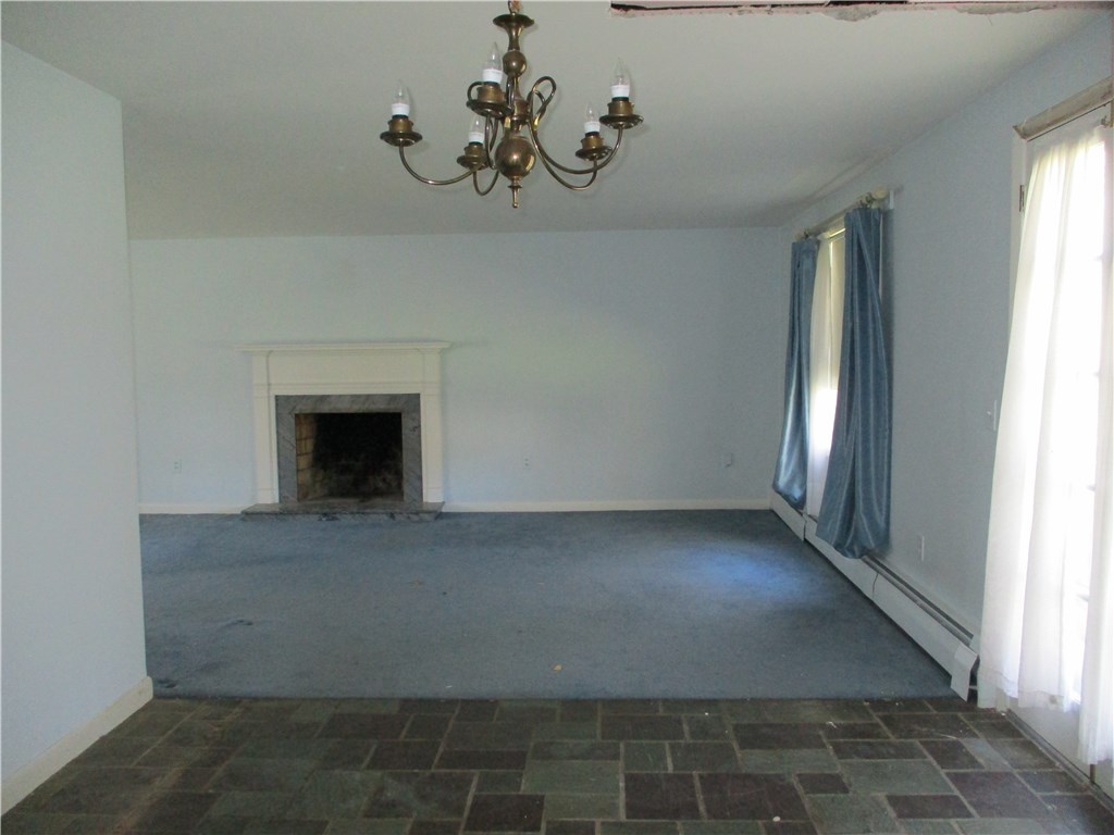 67 Landmark Road Warwick, RI 02886 - Photo 9 of 20 Dining Room w/Flagstone Flooring & Living Room in Rear