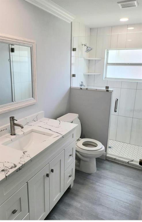 1415 Beach Club Lane Apollo Beach, FL 33572 - Photo 13 of 20 a bathroom with a granite countertop toilet sink and mirror