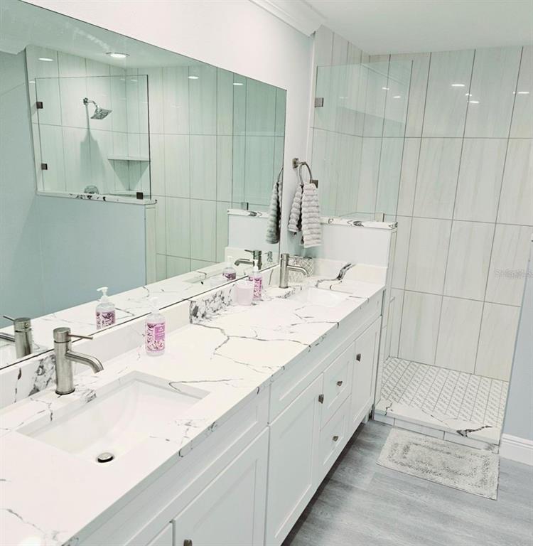 1415 Beach Club Lane Apollo Beach, FL 33572 - Photo 8 of 20 a bathroom with double vanity sink and a mirror