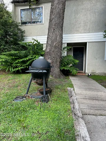 a front view of a house with a yard and an outdoor seating