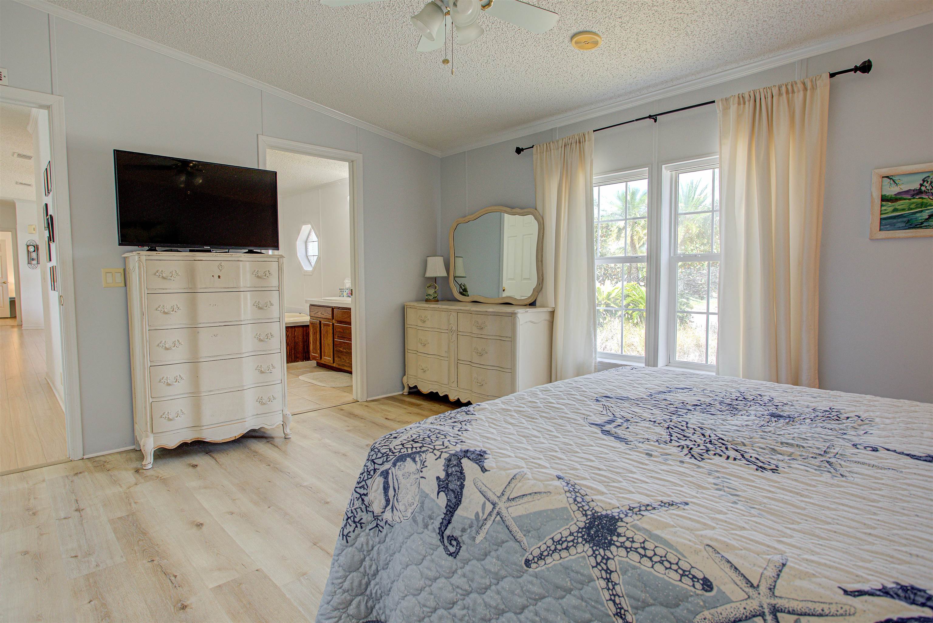 6347 Salado Road St. Augustine, FL 32080 - Photo 14 of 40 a spacious bedroom with a bed and a flat screen tv
